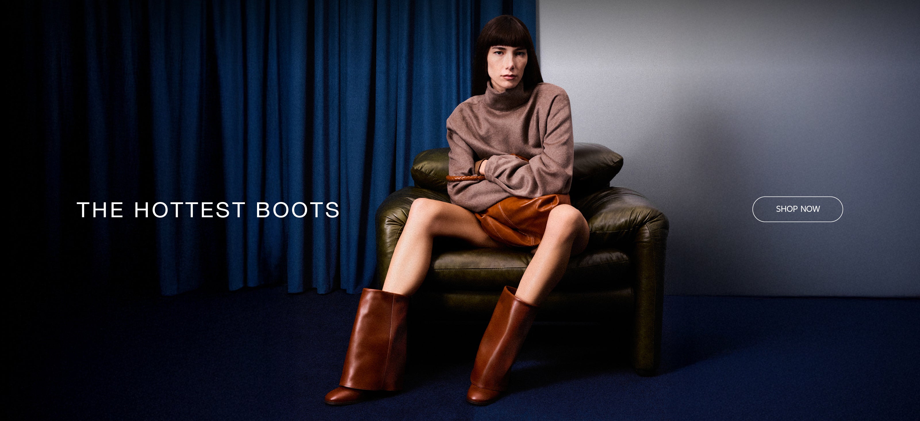 Model wearing oversized brown leather knee-high boots, styled with a beige sweater and leather skirt, from Arezzo.
