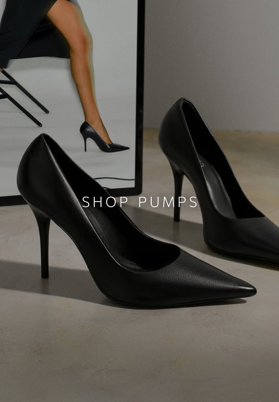 Anne Stiletto Sandal. The style features a high stiletto heel and a rounded toe. It has twisted gold and silver straps over the toes and another diagonal strap across the instep. With a buckle closure and a golden insole with the brand name engraved on it. The style shows the foot. 