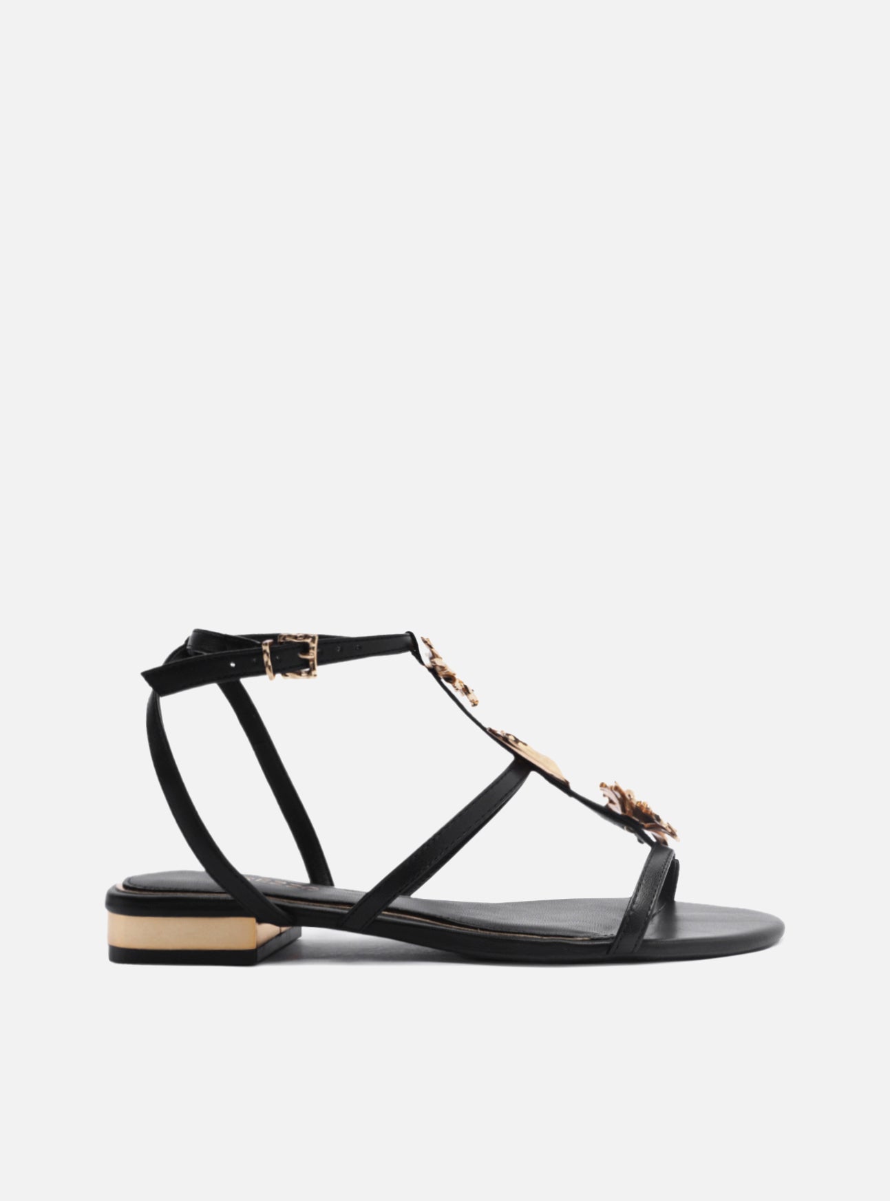 "Black leather sandal with rounded toe. Made in straps, with golden metallic flowers and metallic closure at the ankle. "