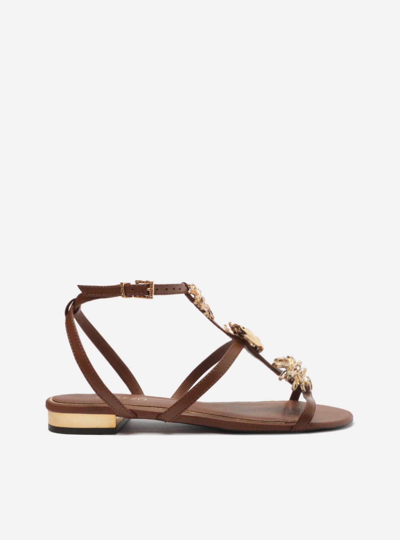 " Brown leather sandal with rounded toe. Made in straps, with golden metallic flowers and metallic closure at the ankle. "