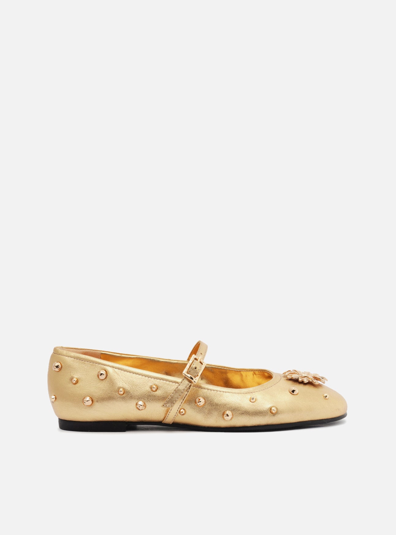 Golden ballet with metallic details throughout the shoe, flat and rounded toe. It is closed, with a round cutout on the vamp and a thin strap on the top with a side metal buckle.