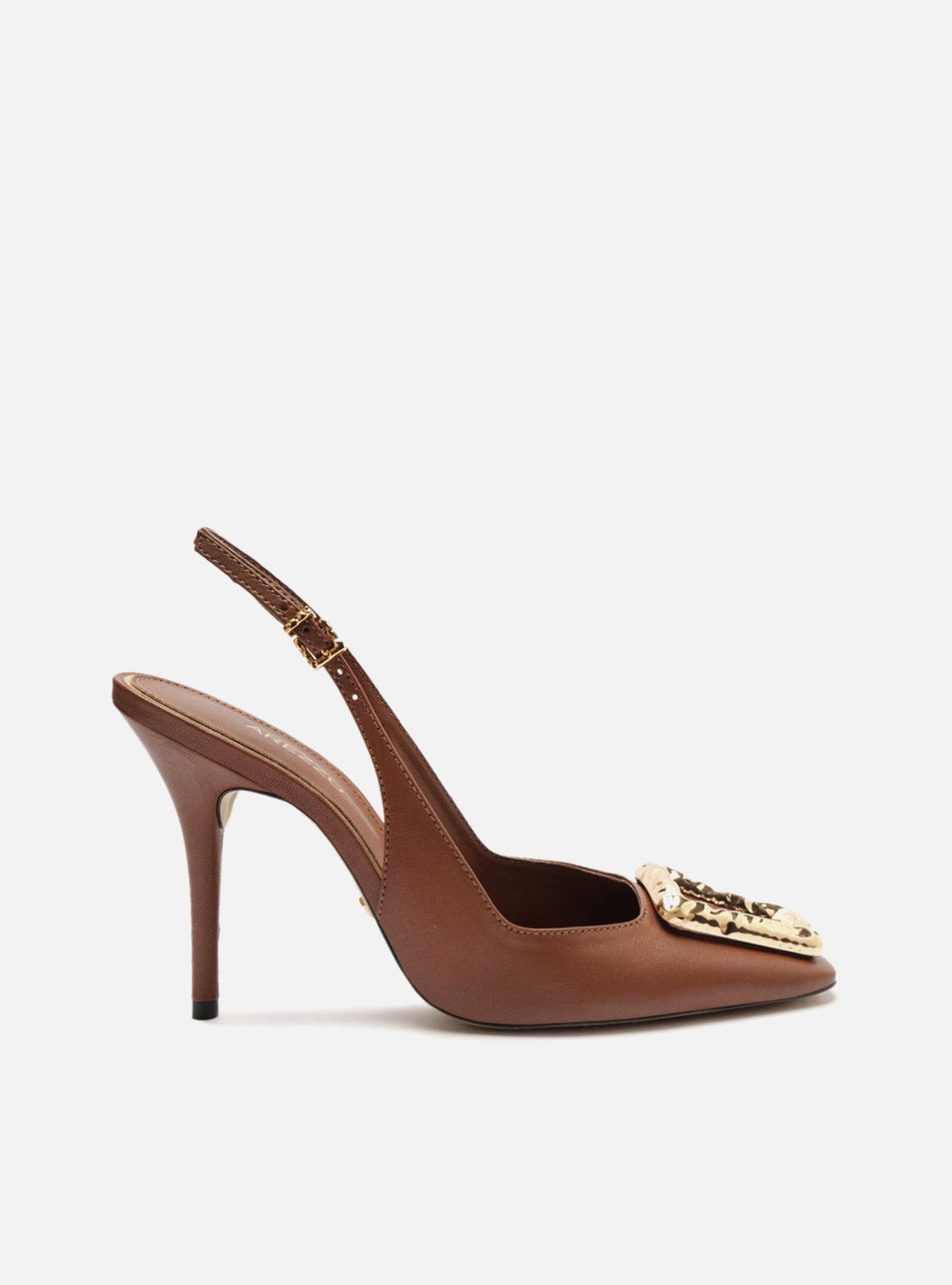 Brown leather pumps with high stiletto heels and square toes. It is closed and has a perforated metal piece on the vamp.