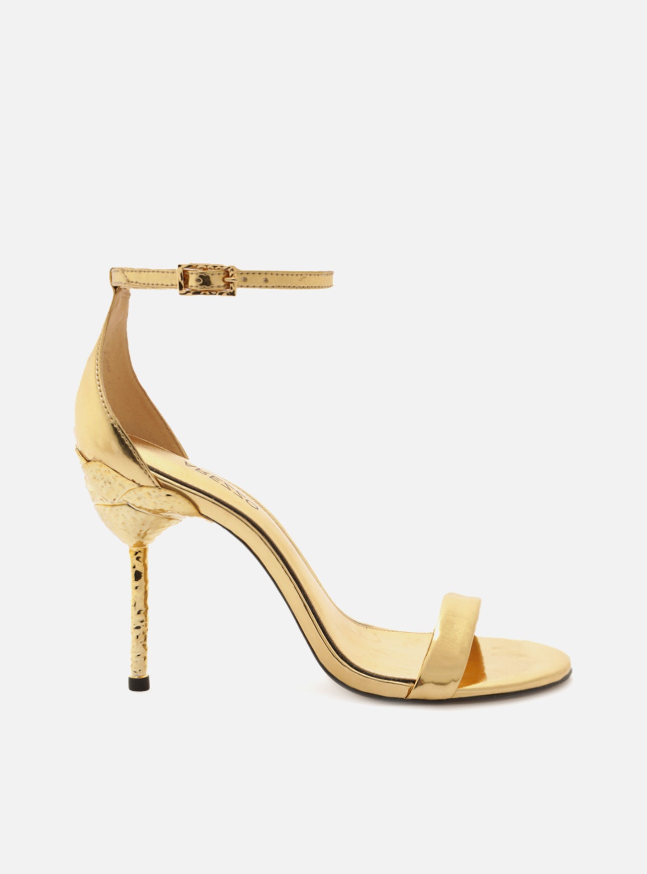 Metallic Gold sandal with a high stiletto heel in hammered gold metal and a rounded toe. Closed heel and ankle strap.
