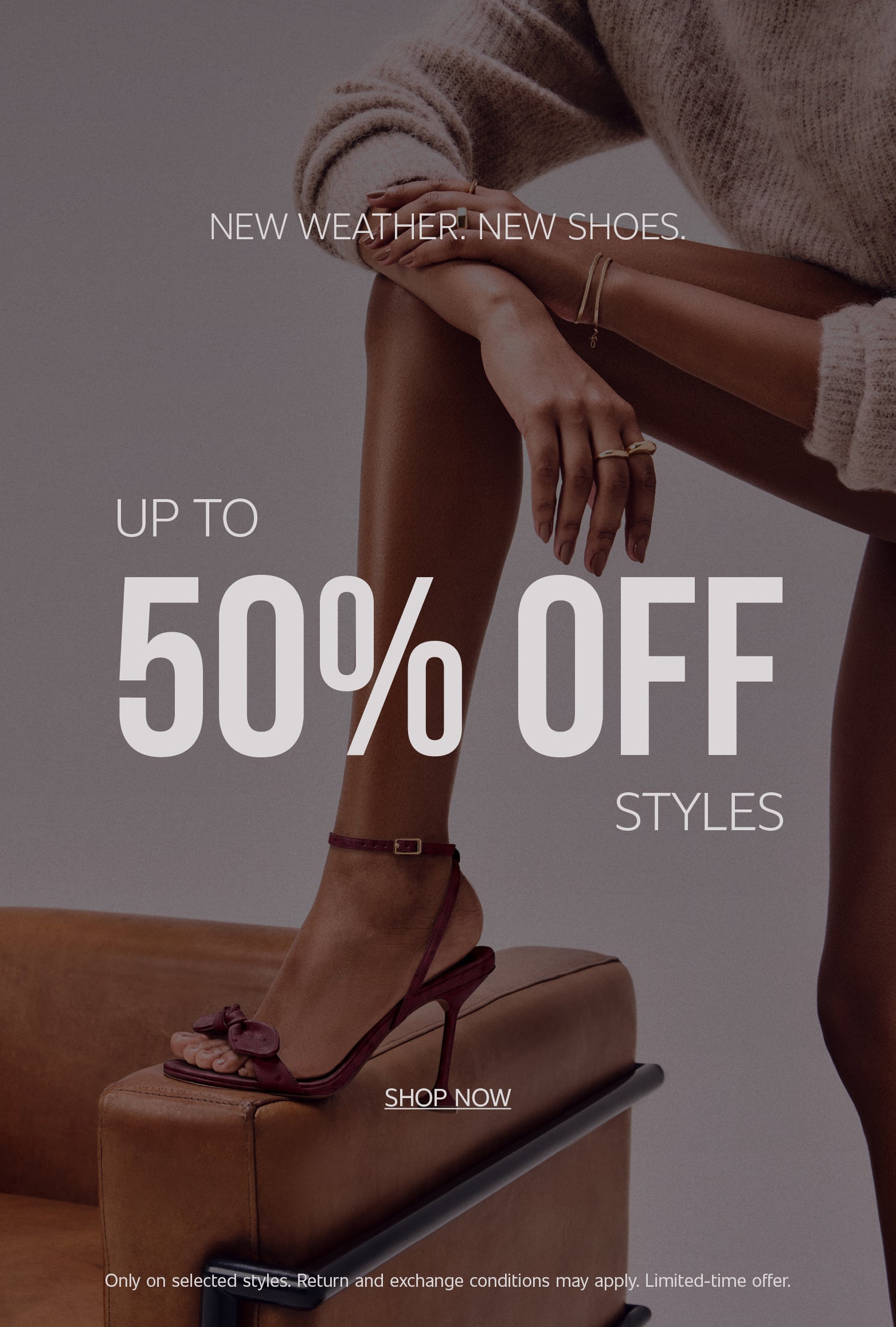 Promotional banner with the text "NEW WEATHER. NEW SHOES." and "UP TO 50% OFF STYLES" in bold burgundy letters. On the left, a model's foot wearing a burgundy strappy high-heeled sandal rests on the armrest of a brown leather armchair. Below the text, there is a "SHOP NOW" call-to-action button, along with fine print detailing offer terms.